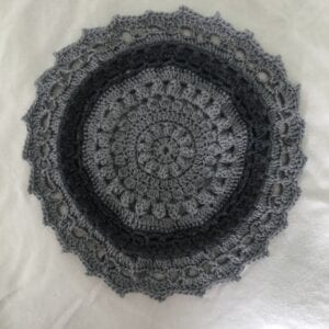 Grey crochet placemat on white background