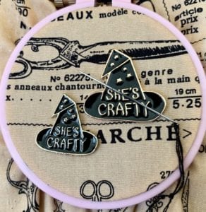 Needle minder tool in the shape of a witch hat, which reads "she's crafty"
